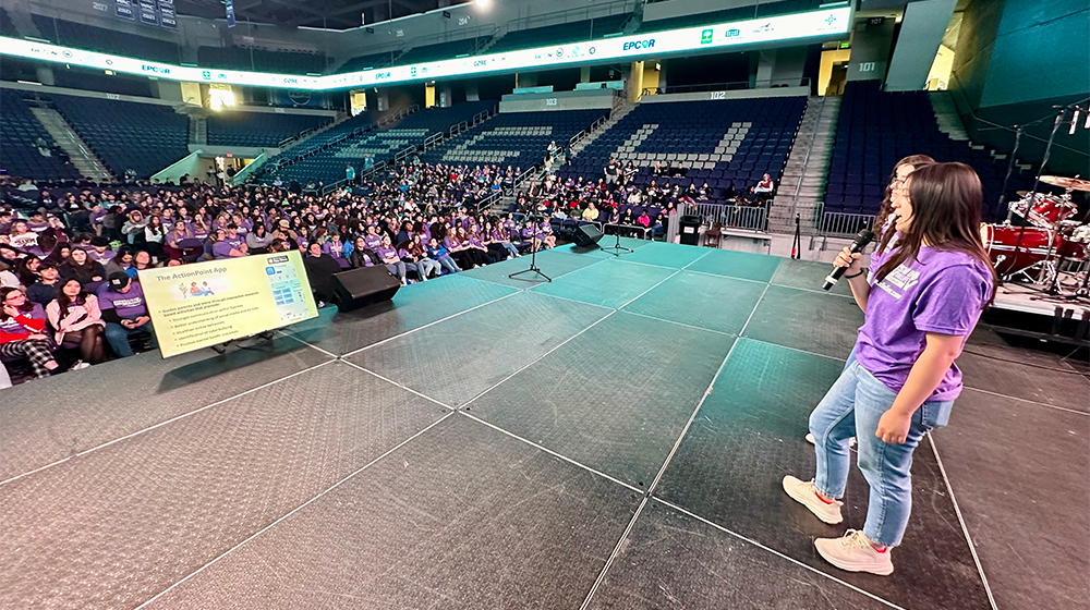 Maddie Juarez speaks on stage at the conference